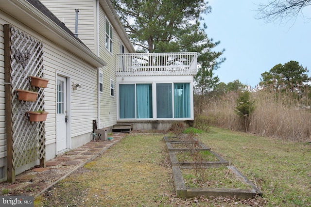 back of property featuring a lawn