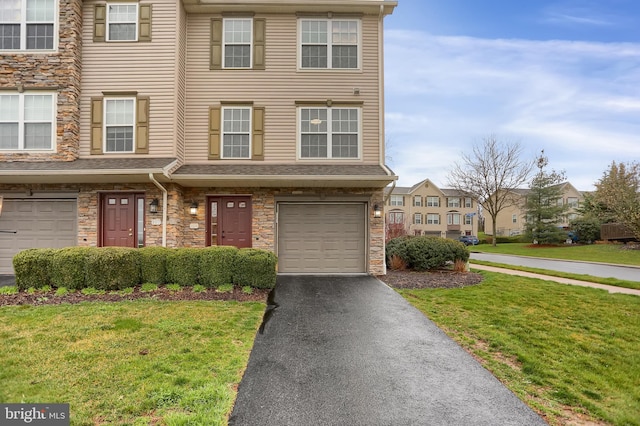 view of property with a front yard and a garage