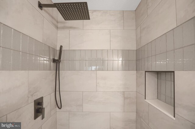 bathroom with a tile shower