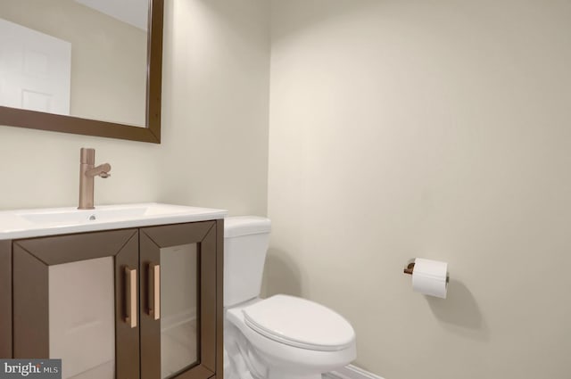 bathroom with toilet and vanity