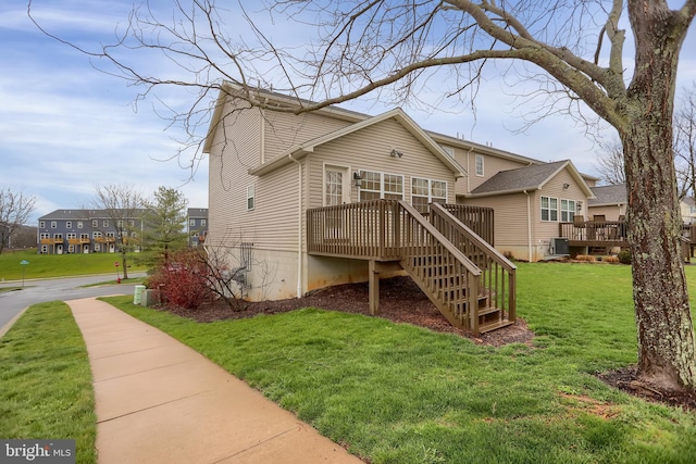 view of property exterior featuring a wooden deck, cooling unit, and a yard