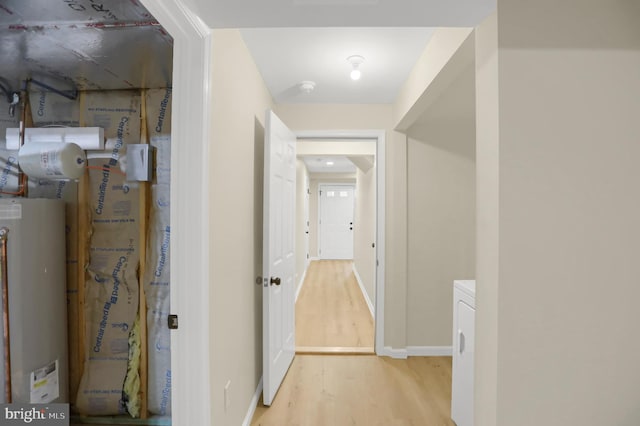 hallway featuring light hardwood / wood-style floors and water heater