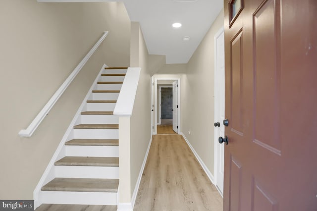 stairs featuring hardwood / wood-style floors