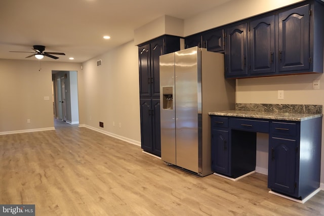 kitchen with stainless steel fridge with ice dispenser, ceiling fan, light hardwood / wood-style floors, and stone countertops