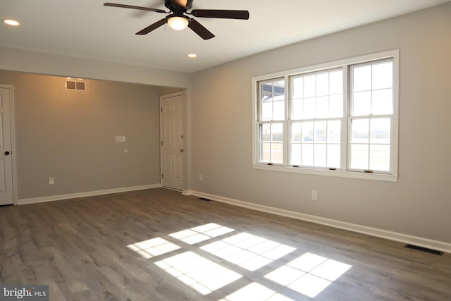 spare room featuring ceiling fan and dark wood-type flooring