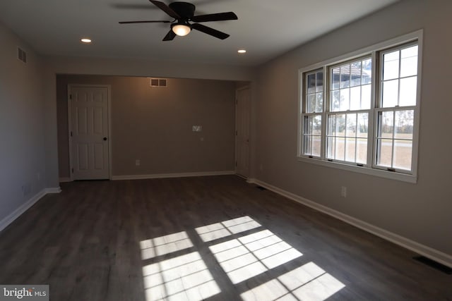 spare room with ceiling fan and dark wood-type flooring