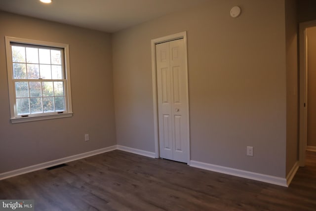 unfurnished room featuring dark hardwood / wood-style floors