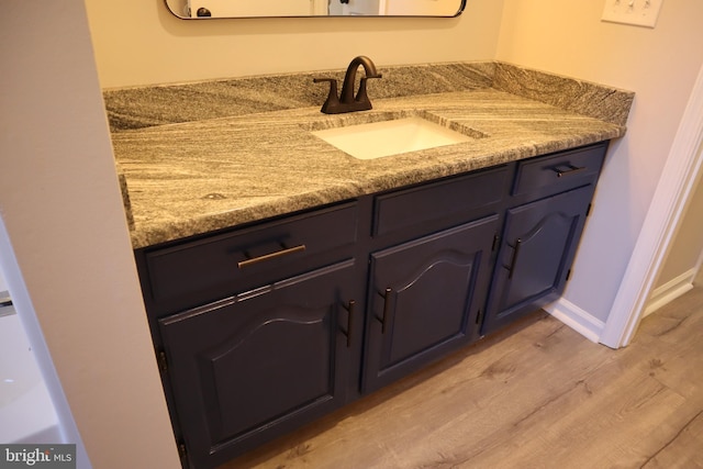 bathroom featuring hardwood / wood-style flooring and vanity