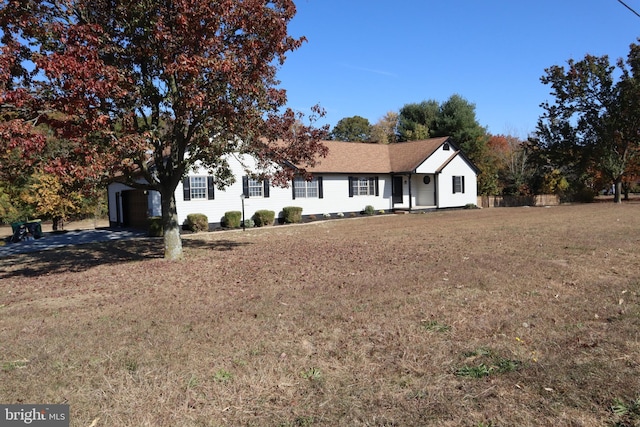 single story home featuring a garage and a front lawn