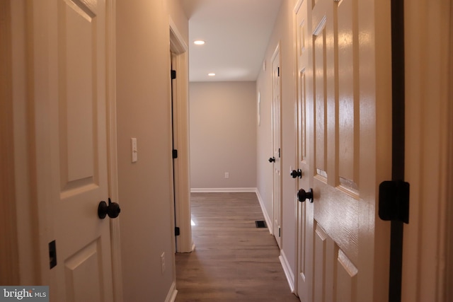 hall with hardwood / wood-style flooring