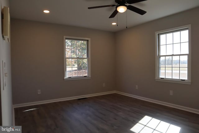 unfurnished room featuring ceiling fan and dark hardwood / wood-style flooring