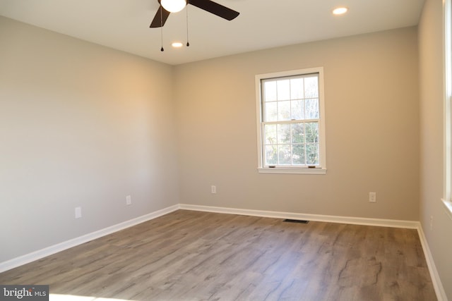 empty room featuring ceiling fan and hardwood / wood-style floors