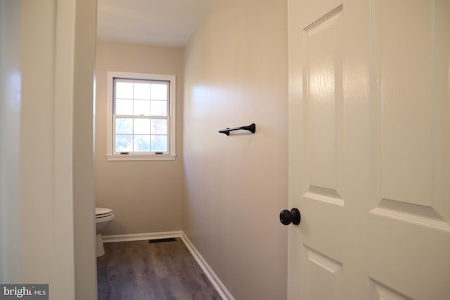 bathroom featuring toilet and hardwood / wood-style flooring