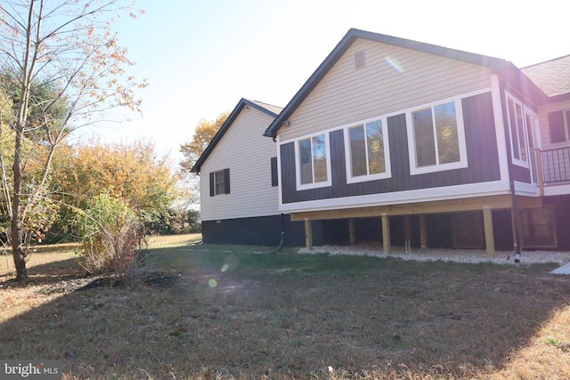 view of property exterior with a yard