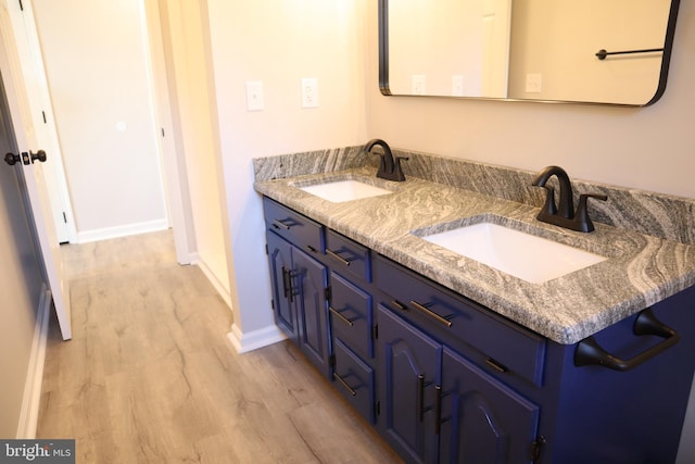 bathroom featuring vanity and hardwood / wood-style floors