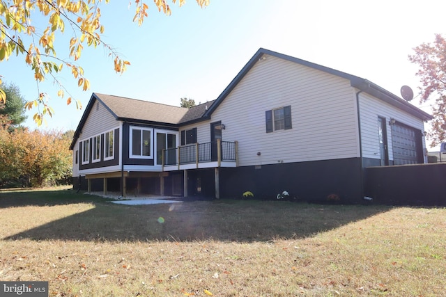 back of property featuring a lawn and a sunroom