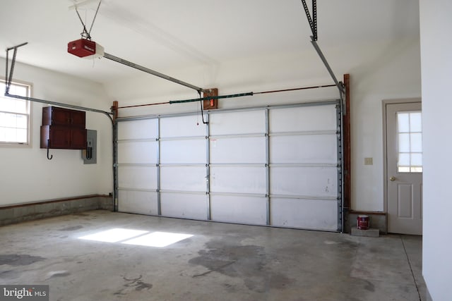 garage with a garage door opener and electric panel