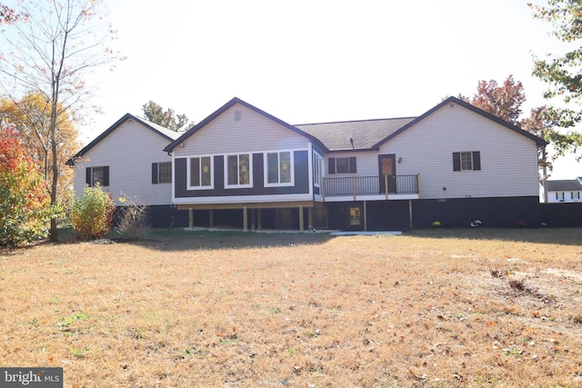 rear view of property featuring a yard