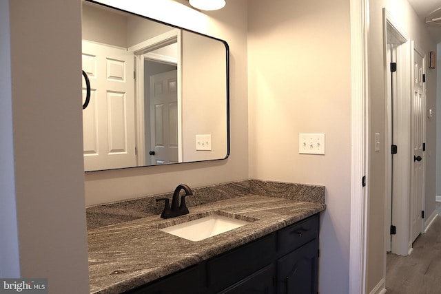 bathroom featuring hardwood / wood-style floors and vanity