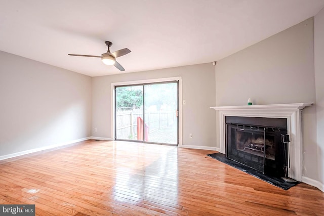 unfurnished living room featuring ceiling fan and light hardwood / wood-style flooring