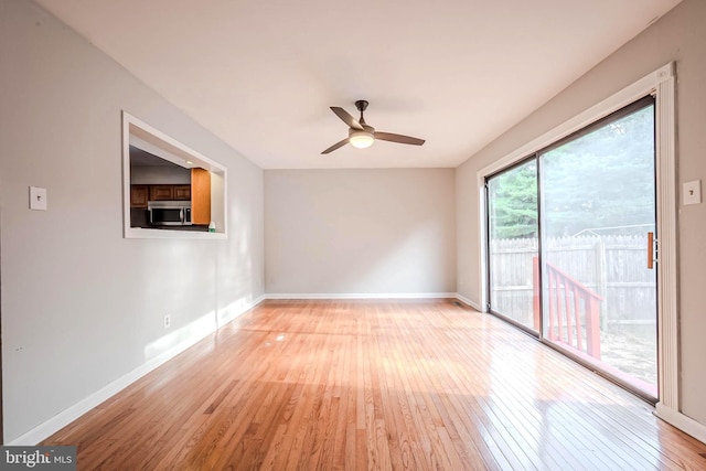 unfurnished room with ceiling fan and light wood-type flooring