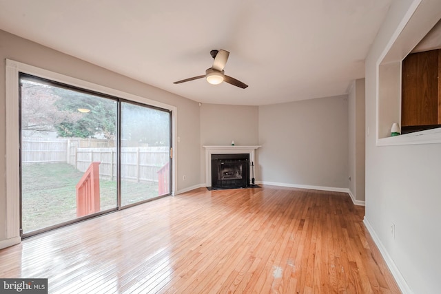 unfurnished living room with ceiling fan and light hardwood / wood-style flooring