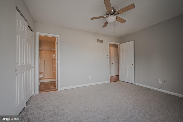 unfurnished bedroom with light carpet, ceiling fan, and ensuite bath