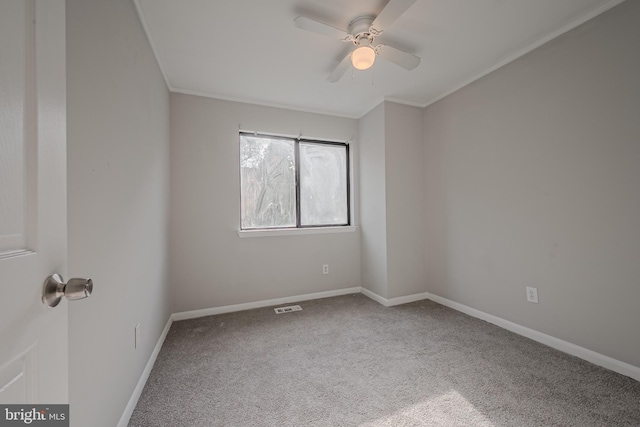 unfurnished room featuring crown molding, carpet flooring, and ceiling fan