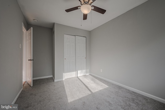 unfurnished bedroom with a closet, carpet floors, and ceiling fan