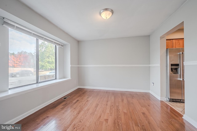 spare room featuring light wood-type flooring