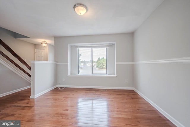 unfurnished room featuring hardwood / wood-style flooring