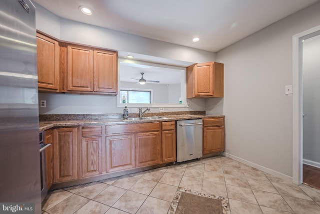 kitchen featuring ceiling fan, stainless steel appliances, sink, and light tile patterned floors