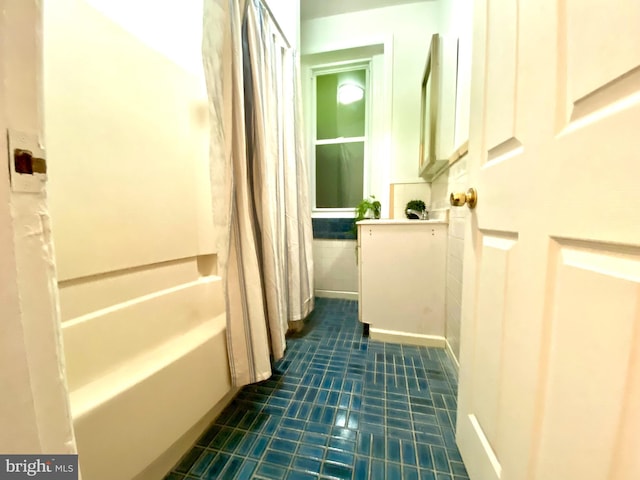 hall featuring dark tile patterned flooring