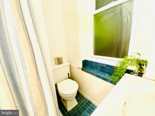 bathroom with tile patterned flooring, sink, and toilet