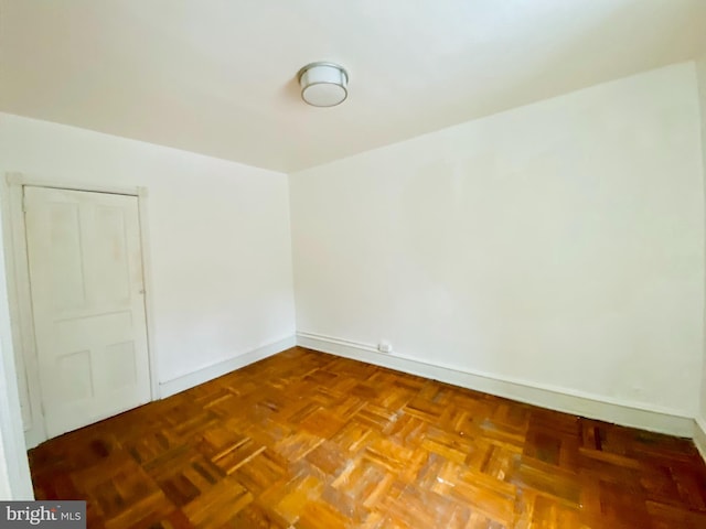 empty room with parquet flooring