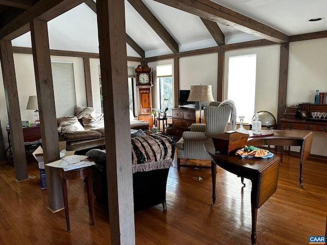 bedroom with vaulted ceiling with beams and hardwood / wood-style floors