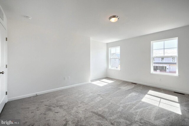 empty room with carpet and baseboards