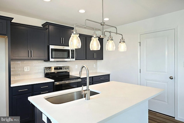 kitchen featuring a sink, appliances with stainless steel finishes, and light countertops