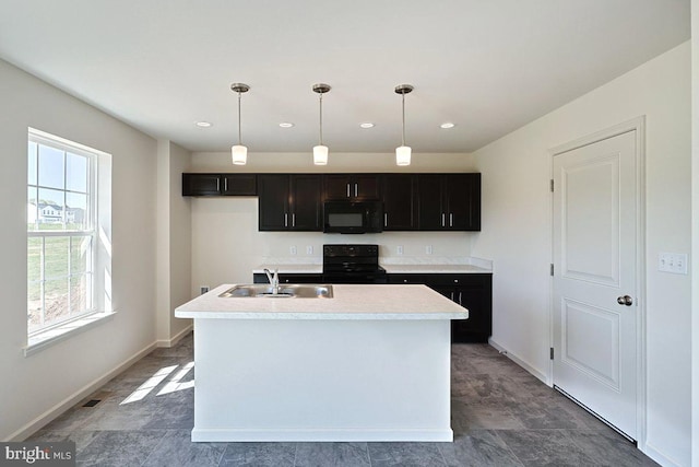 kitchen with black appliances, decorative light fixtures, light countertops, and a sink