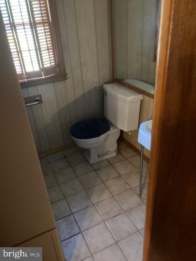 bathroom with toilet and tile patterned floors