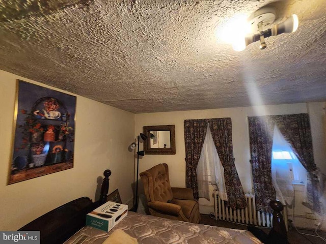 unfurnished bedroom featuring radiator and a textured ceiling