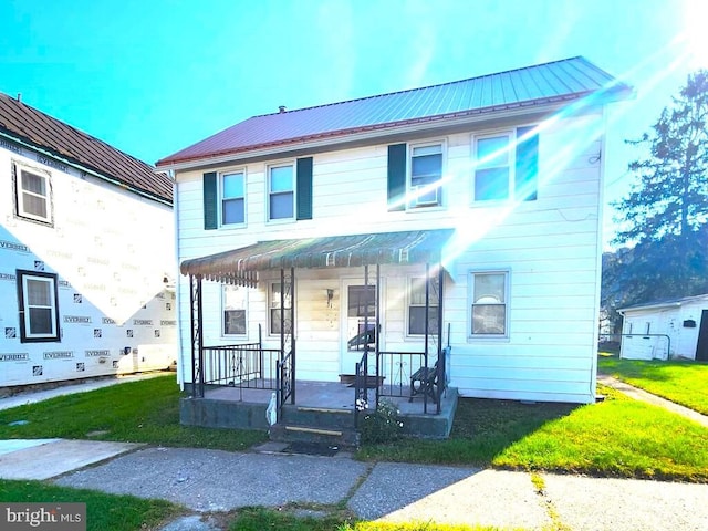 view of front of house with covered porch and a front lawn