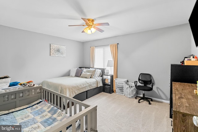 bedroom with ceiling fan and light carpet