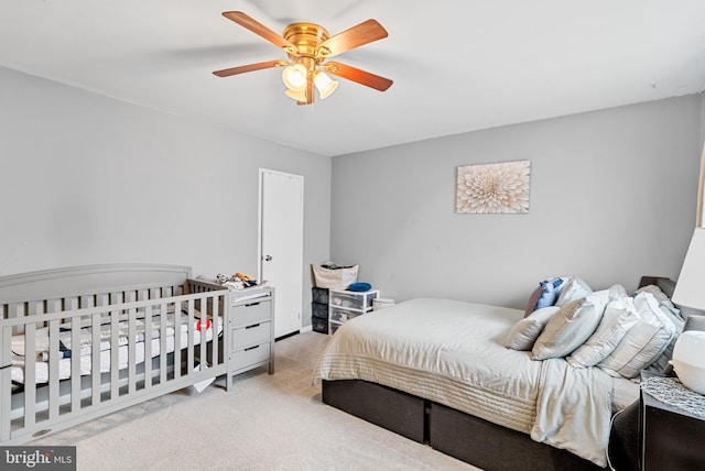 bedroom featuring ceiling fan and light colored carpet