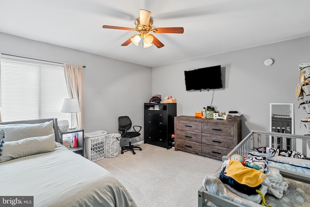 bedroom with light colored carpet and ceiling fan