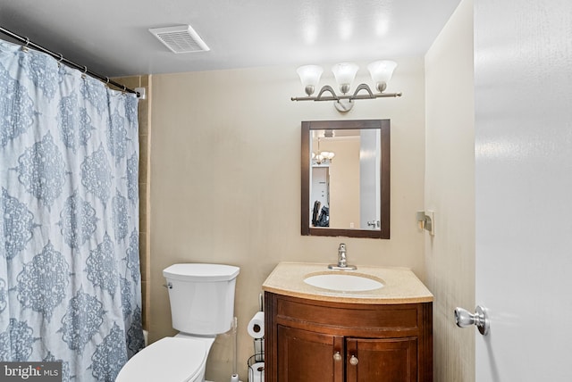 bathroom featuring vanity, toilet, and curtained shower