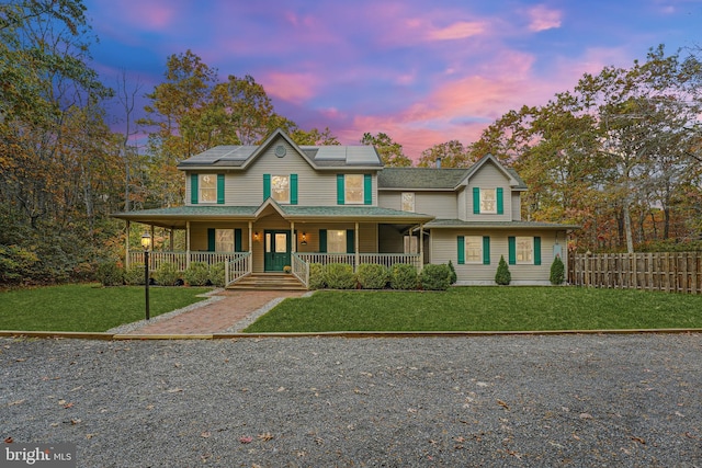 view of front facade featuring a yard and covered porch