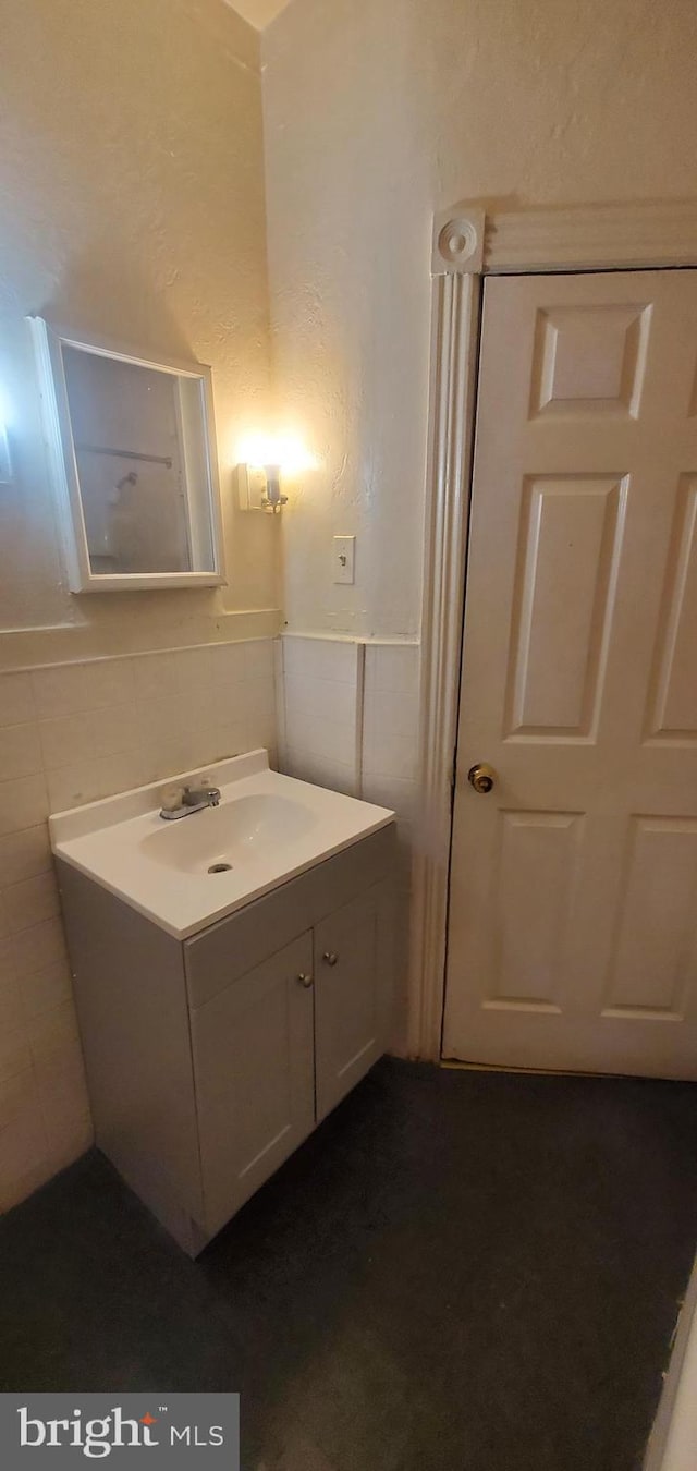 bathroom featuring tile walls and vanity