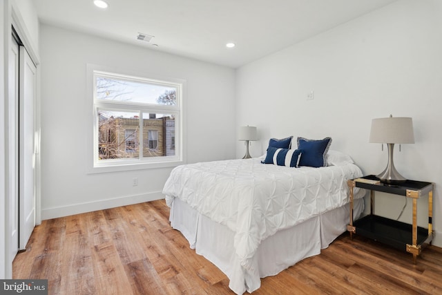 bedroom featuring hardwood / wood-style floors and a closet