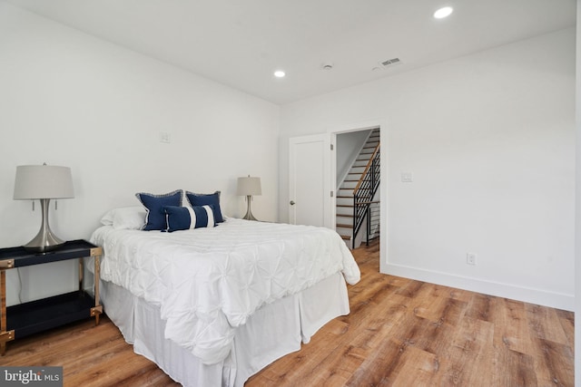 bedroom with hardwood / wood-style flooring